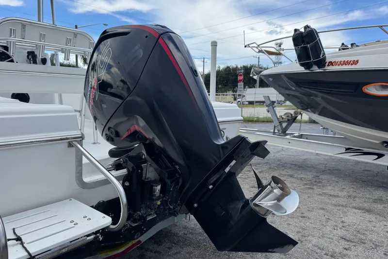 Slide: The Image of 2004 Sea Fox 225 Bay Fisher boat with powerful outboard motor in a marina setting. - 35