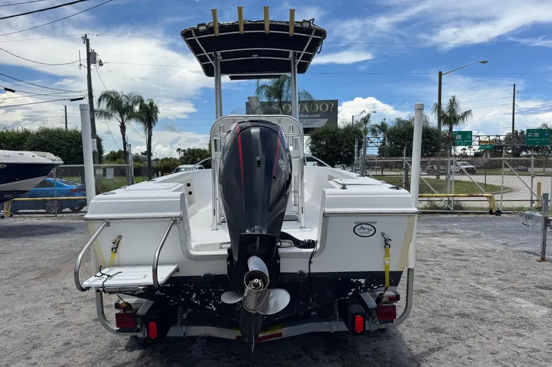 Slide: The Image of 2004 Sea Fox 225 Bay Fisher boat with outboard motor, parked outdoors. - 4