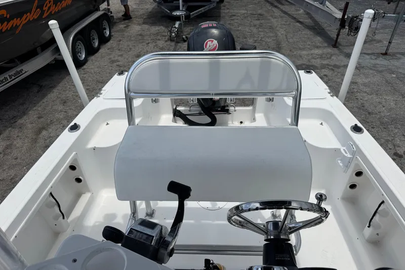 Slide: The Image of 2004 Sea Fox 225 Bay Fisher boat interior with steering wheel and seating. - 15