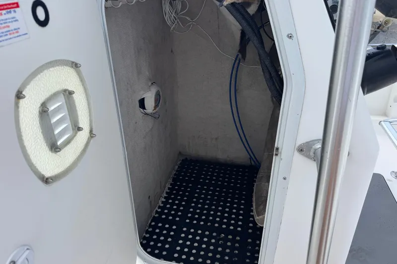 Slide: The Image of Interior view of a 2004 Sea Fox 225 Bay Fisher boat storage compartment. - 25
