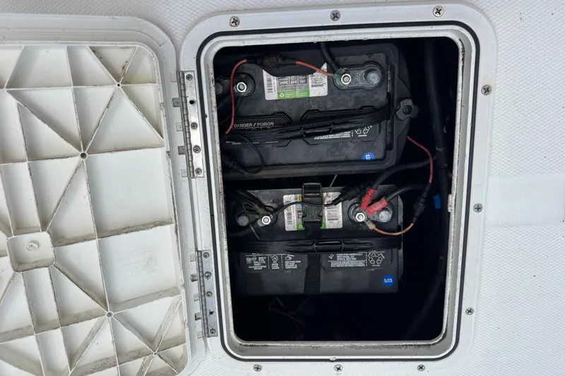 Slide: The Image of Battery compartment of a 2004 Sea Fox 225 Bay Fisher boat, showing two marine batteries. - 27