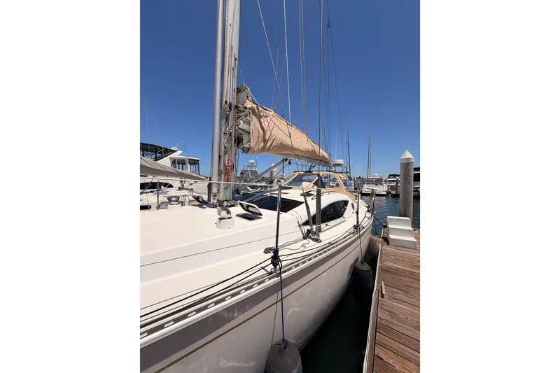 Slide: The Image of Sailboat docked at marina, Saga 409 model, 2007, under clear blue sky. - 11
