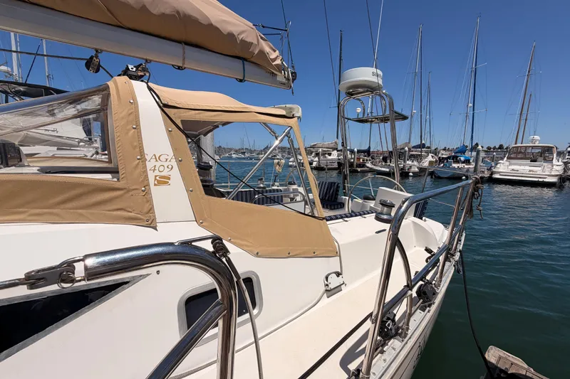 Slide: The Image of Sailboat Saga 409, 2007 model, docked at marina with clear blue sky. - 14