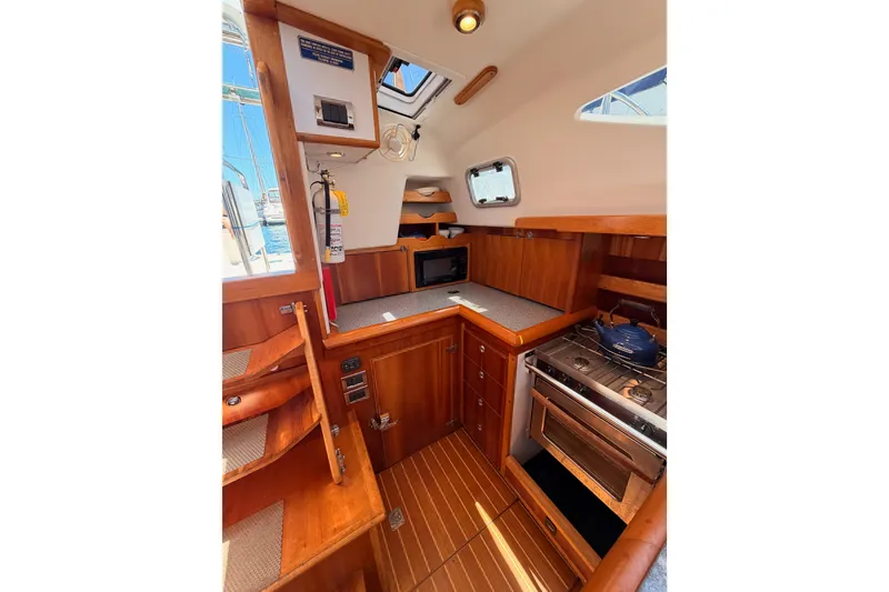 Slide: The Image of Cozy 2007 Saga 409 yacht kitchen with wooden cabinetry and modern appliances. - 60
