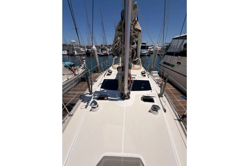Slide: The Image of 2007 Saga 409 sailboat docked at marina, showcasing deck and rigging. - 25