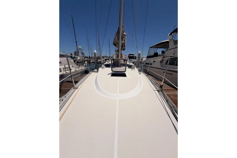 Slide: The Image of Sailboat deck view of 2007 Saga 409, docked at marina under clear blue sky. - 24
