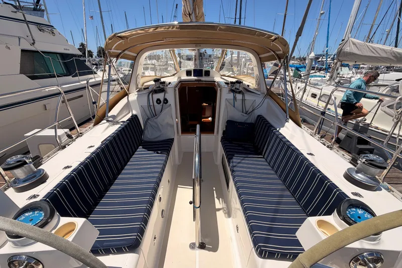 Slide: The Image of 2007 Saga 409 sailboat cockpit with striped seating, docked in a marina. - 50