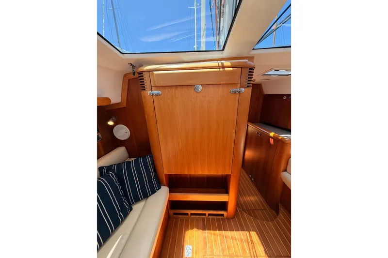 Slide: The Image of Interior of 2007 Saga 409 yacht with wooden cabinetry and striped cushions. - 90