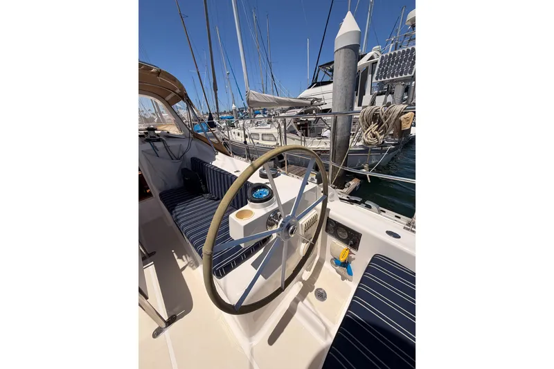 Slide: The Image of Steering wheel of a 2007 Saga 409 sailboat docked at a marina. - 47