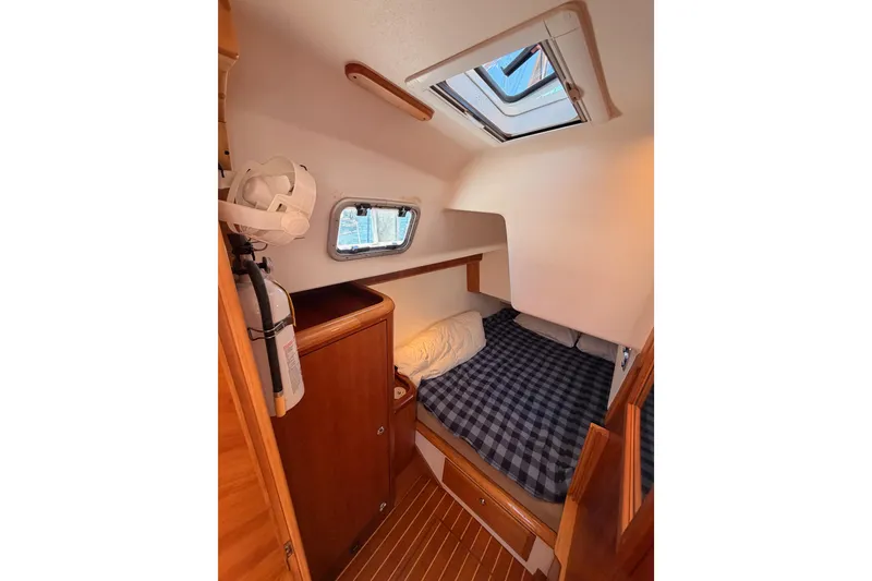 Slide: The Image of Cozy cabin interior of 2007 Saga 409 sailboat with plaid bedding and wooden accents. - 78