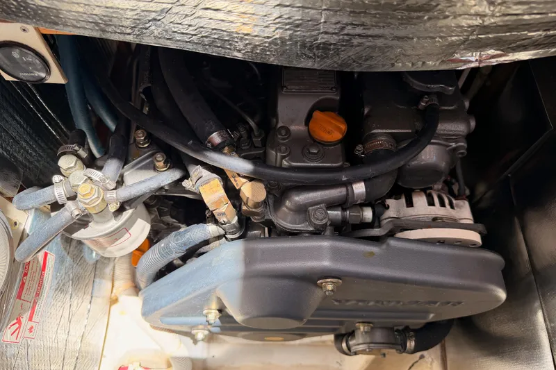 Slide: The Image of Engine compartment of a 2007 Saga 409, showcasing mechanical components and wiring. - 119
