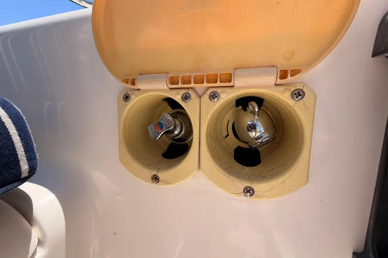 Slide: The Image of Boat water and fuel inlets on a 2007 Saga 409, with open yellow cover. - 45