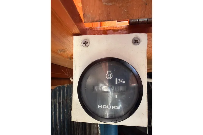 Slide: The Image of Hour meter on a 2007 Saga 409 boat, mounted on a wooden surface. - 117