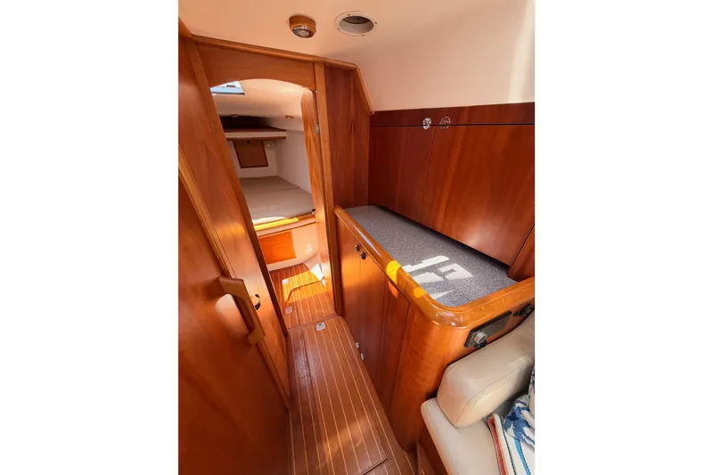 Slide: The Image of Interior of 2007 Saga 409 yacht with wooden cabinetry and cozy sleeping area. - 95