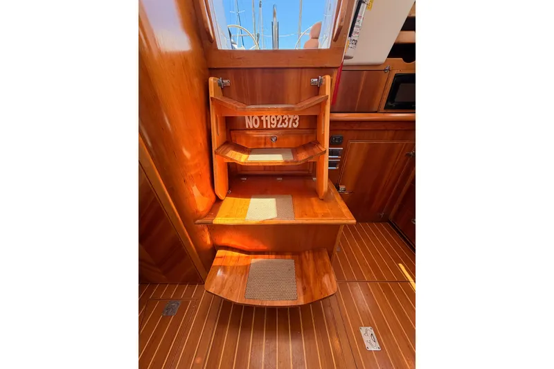 Slide: The Image of Wooden interior stairs of 2007 Saga 409 boat, featuring rich wood finish and textured steps. - 115