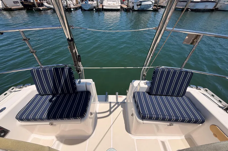 Slide: The Image of Two striped cushioned seats on a 2007 Saga 409 boat, docked at a marina. - 36