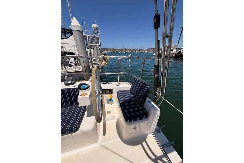 Slide: The Image of Cockpit of 2007 Saga 409 sailboat with striped seating, docked in marina. - 46