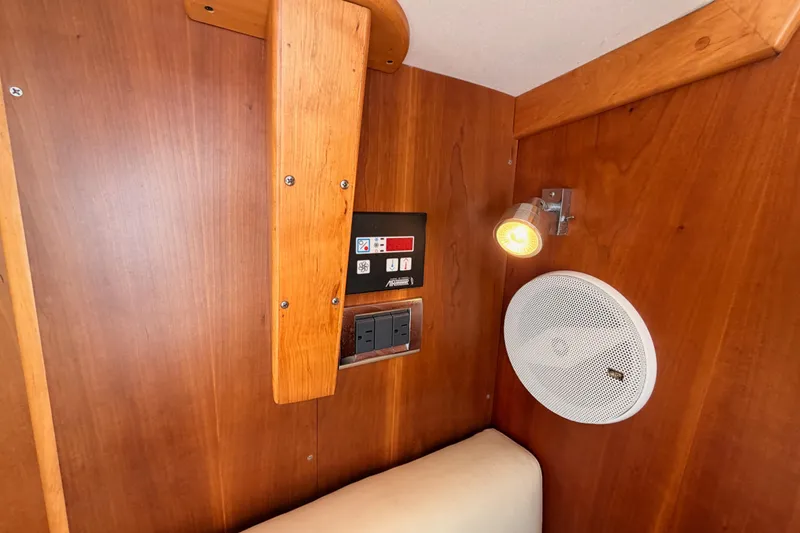 Slide: The Image of Wooden interior of 2007 Saga 409 boat with control panel, light, and speaker. - 89