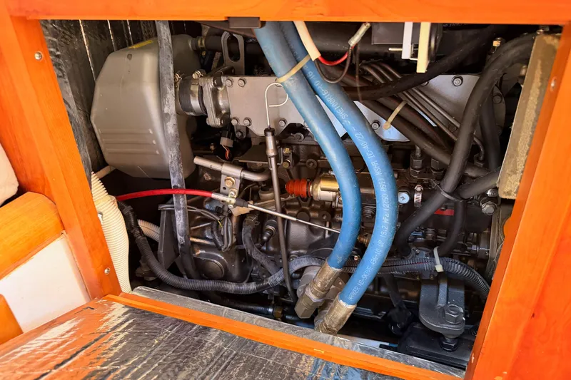 Slide: The Image of Engine compartment of a 2007 Saga 409 boat, featuring hoses and mechanical components. - 120