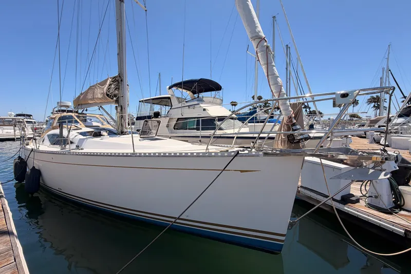 Slide: The Image of Sailboat docked at marina, Saga 409 model, 2007, with clear blue sky background. - 7