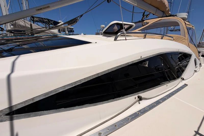 Slide: The Image of 2007 Saga 409 sailboat deck with sleek windows and rigging details. - 12
