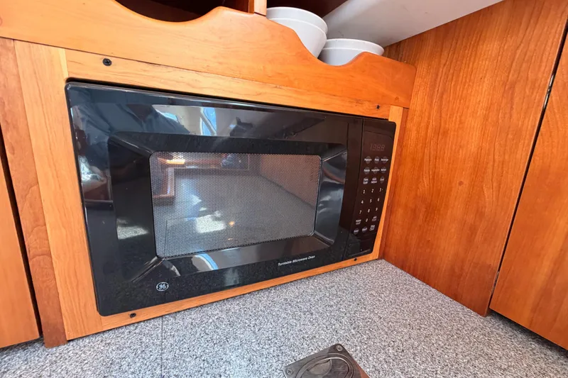 Slide: The Image of Built-in microwave in wooden cabinetry on a 2007 Saga 409 boat. - 66