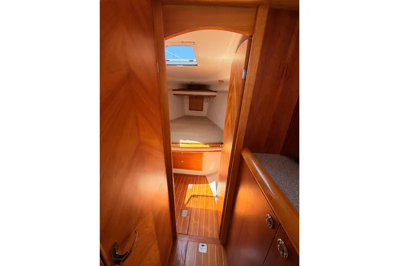 Slide: The Image of Interior view of 2007 Saga 409 sailboat cabin with wooden finish and cozy sleeping area. - 101