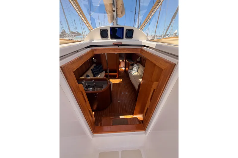 Slide: The Image of Interior view of 2007 Saga 409 sailboat, featuring wooden finishes and cozy seating area. - 56