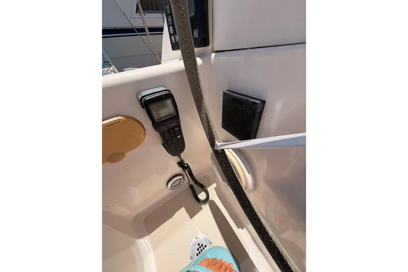 Slide: The Image of Boat cockpit with radio equipment, Saga 409, 2007 model, featuring a foot in sandals. - 44