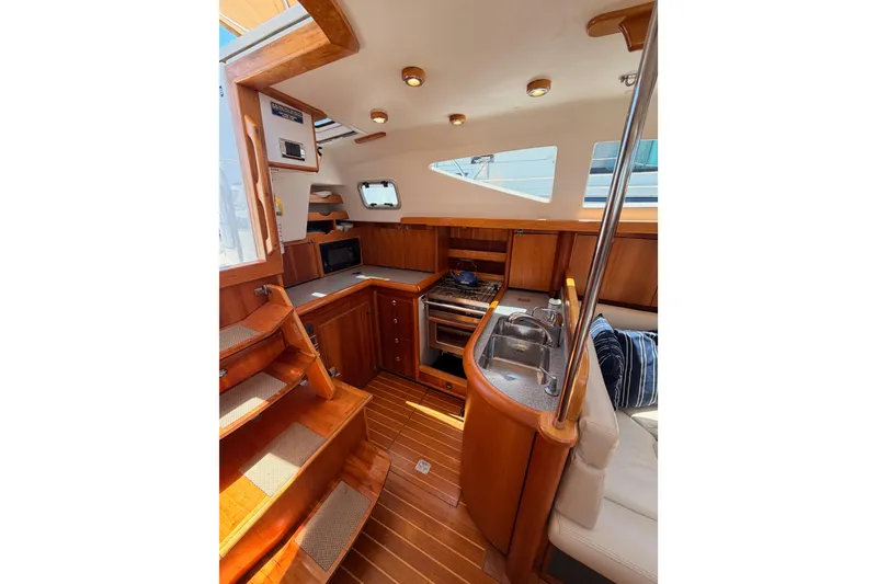Slide: The Image of Interior of 2007 Saga 409 yacht with wooden cabinetry and modern kitchen amenities. - 59