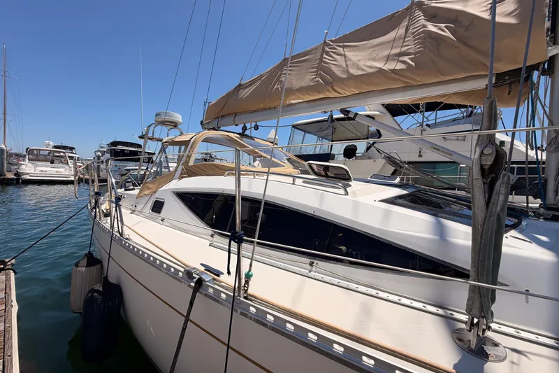 Slide: The Image of Sailboat docked at marina, Saga 409 model, 2007, with beige sail cover. - 5