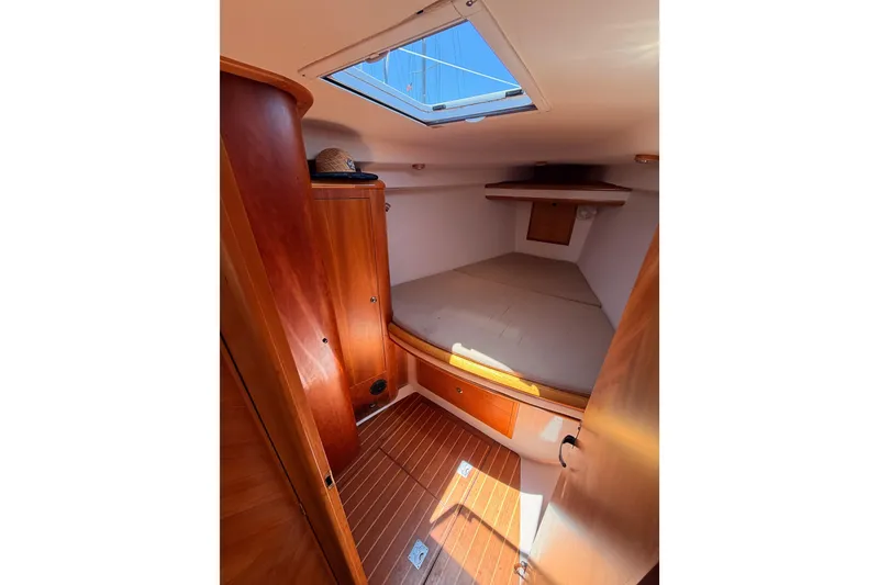 Slide: The Image of Cozy cabin interior of 2007 Saga 409 sailboat with wooden finishes and skylight. - 102