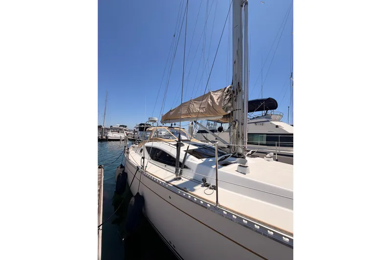 Slide: The Image of Sailboat docked at marina, Saga 409 model, 2007, under clear blue sky. - 6