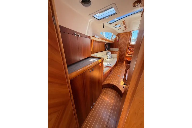 Slide: The Image of Luxurious 2007 Saga 409 yacht interior with wooden cabinetry and cozy seating. - 107