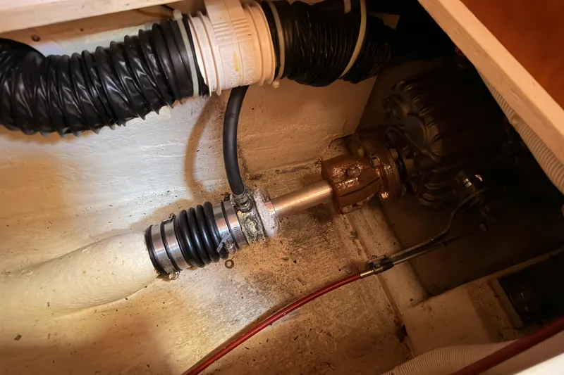 Slide: The Image of Boat engine compartment of a 2007 Saga 409, showing mechanical components and hoses. - 121