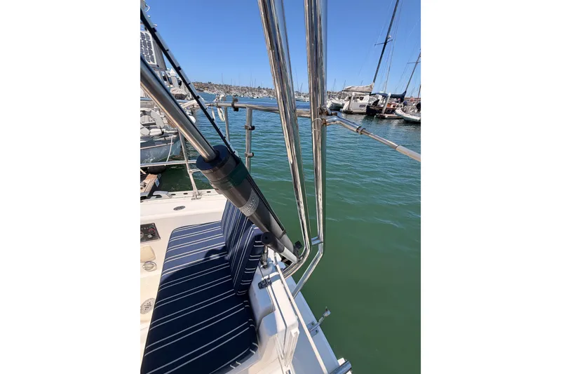 Slide: The Image of Deck view of 2007 Saga 409 sailboat with striped seating, docked in a marina. - 38