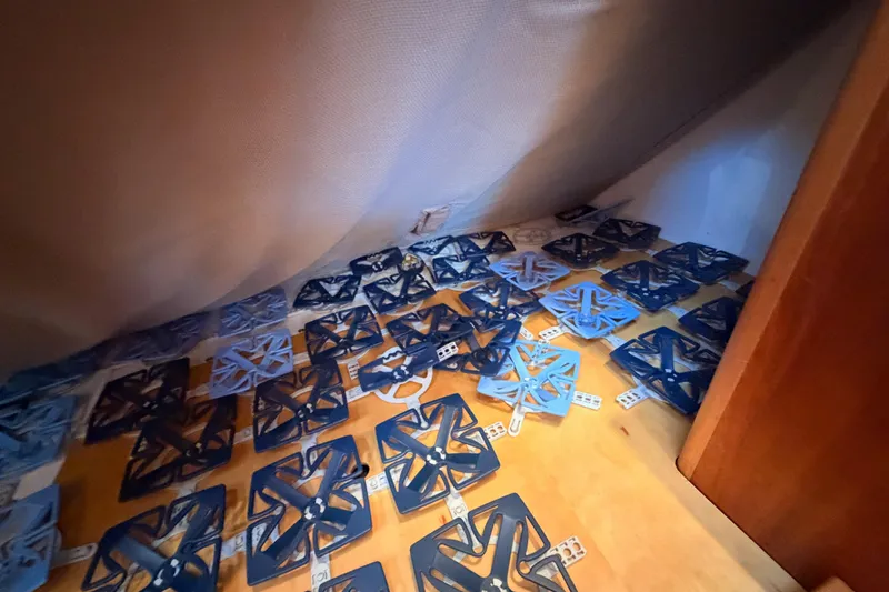 Slide: The Image of Under-bed storage with blue plastic grid structures in a 2007 Saga 409 model. - 122