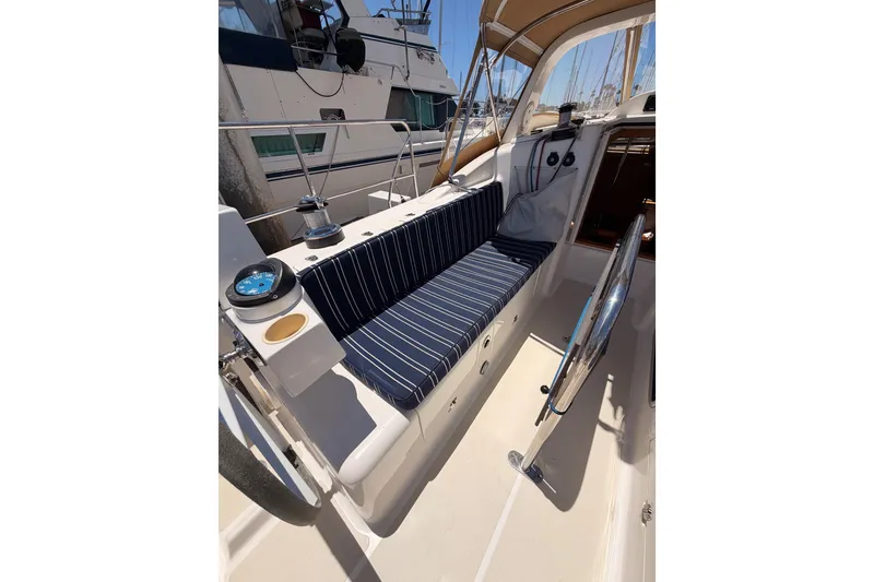 Slide: The Image of Cockpit of 2007 Saga 409 sailboat with striped seating and steering wheel. - 51