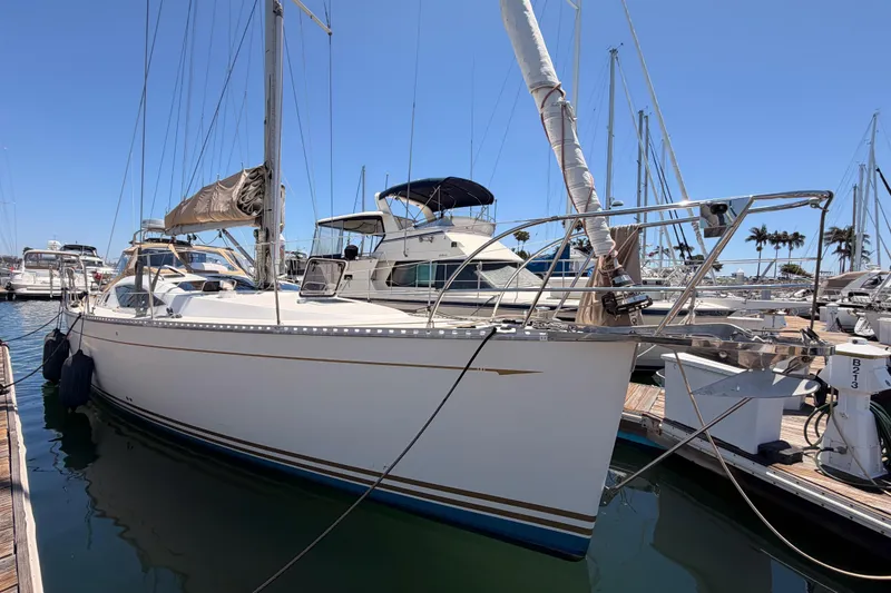 Slide: The Image of Sailboat docked at marina, Saga 409 model, 2007, with clear blue sky background. - 1