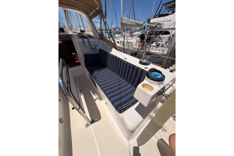 Slide: The Image of Cockpit of 2007 Saga 409 sailboat with striped seating and navigational equipment. - 52