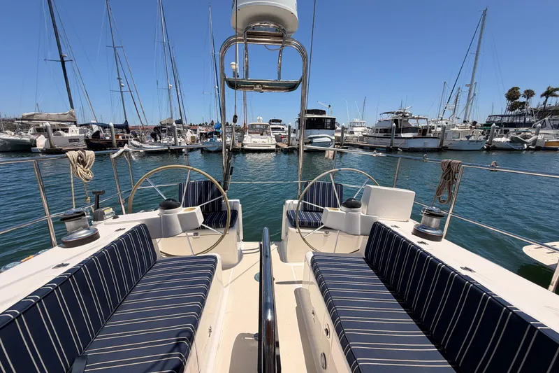 Slide: The Image of Sailboat Saga 409 (2007) docked in marina, featuring striped seating and dual steering wheels. - 31