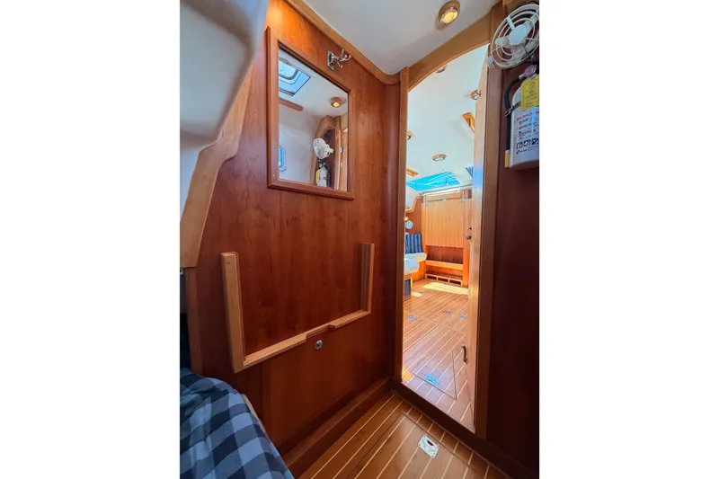 Slide: The Image of Interior of 2007 Saga 409 sailboat with wooden paneling and seating area. - 82