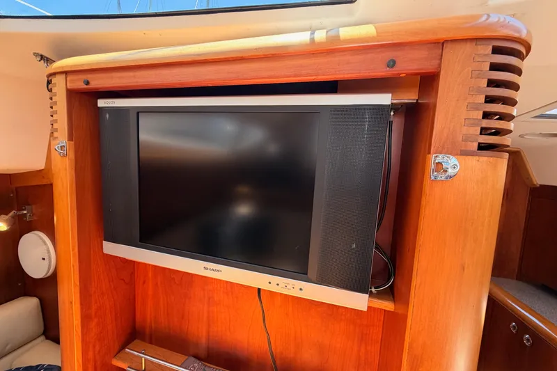 Slide: The Image of Flat-screen TV mounted in a 2007 Saga 409 yacht's wooden interior. - 114
