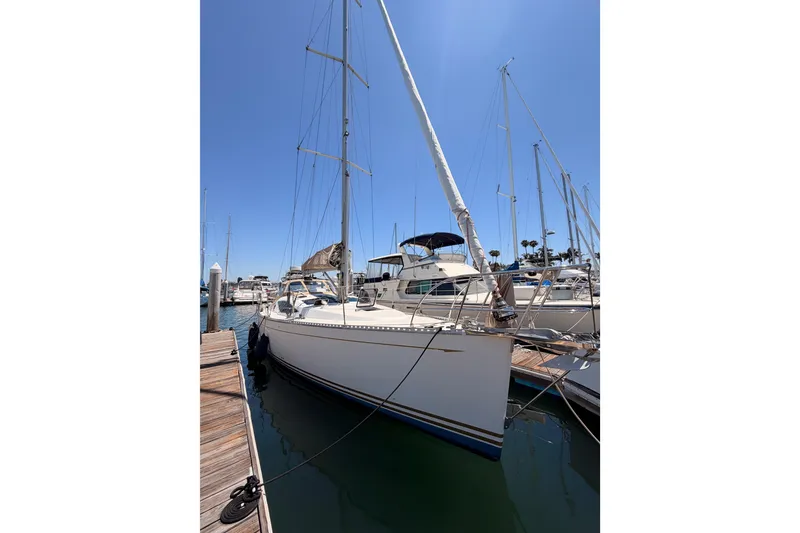 Slide: The Image of Sailboat docked at marina, Saga 409 model, 2007, under clear blue sky. - 2