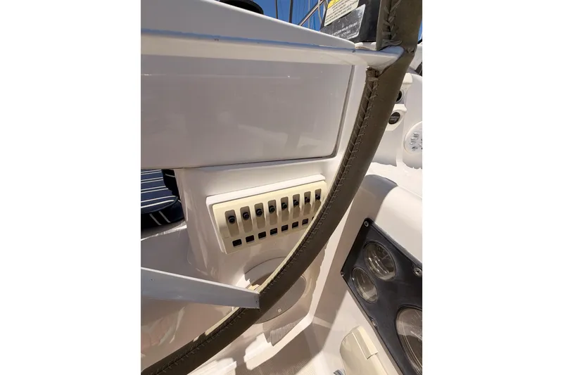 Slide: The Image of Control panel on a 2007 Saga 409 boat, featuring multiple switches and gauges. - 49