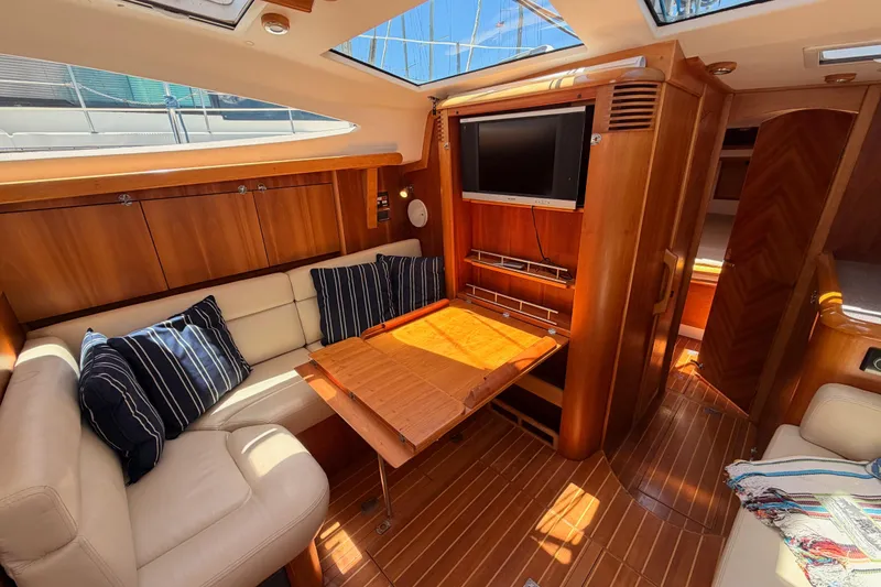 Slide: The Image of Luxurious 2007 Saga 409 yacht interior with wood finish, seating, and TV. - 112