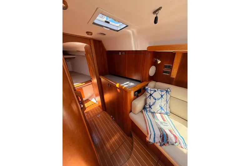 Slide: The Image of Interior of 2007 Saga 409 sailboat with cozy seating and wooden finishes. - 92