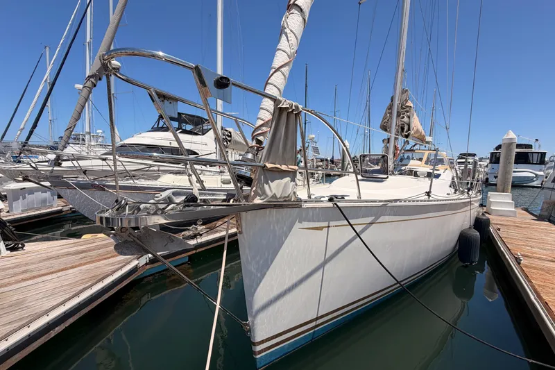 Slide: The Image of Sailboat docked at marina, Saga 409 model, 2007, with clear blue sky background. - 9