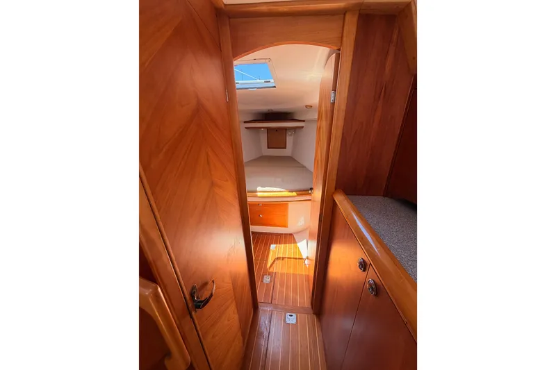 Slide: The Image of Cozy wooden interior of 2007 Saga 409 sailboat cabin with bed and storage. - 96