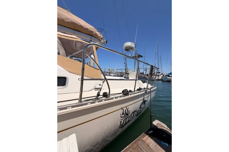 Slide: The Image of 2007 Saga 409 sailboat docked at marina, featuring sleek design and stainless steel railings. - 15